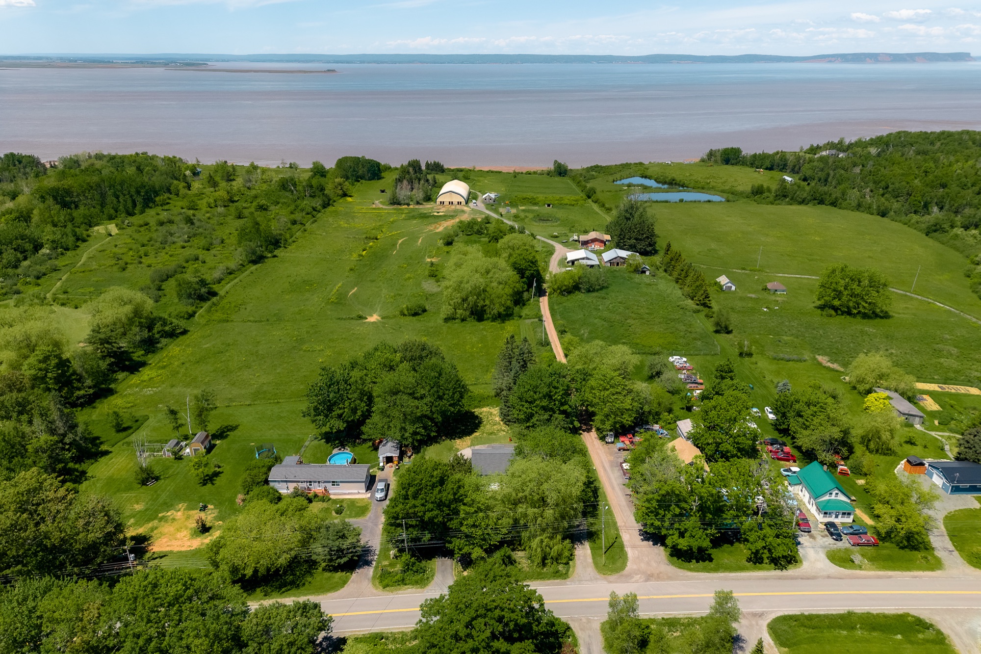 Aerial of fields and trees with the basin on the horizon