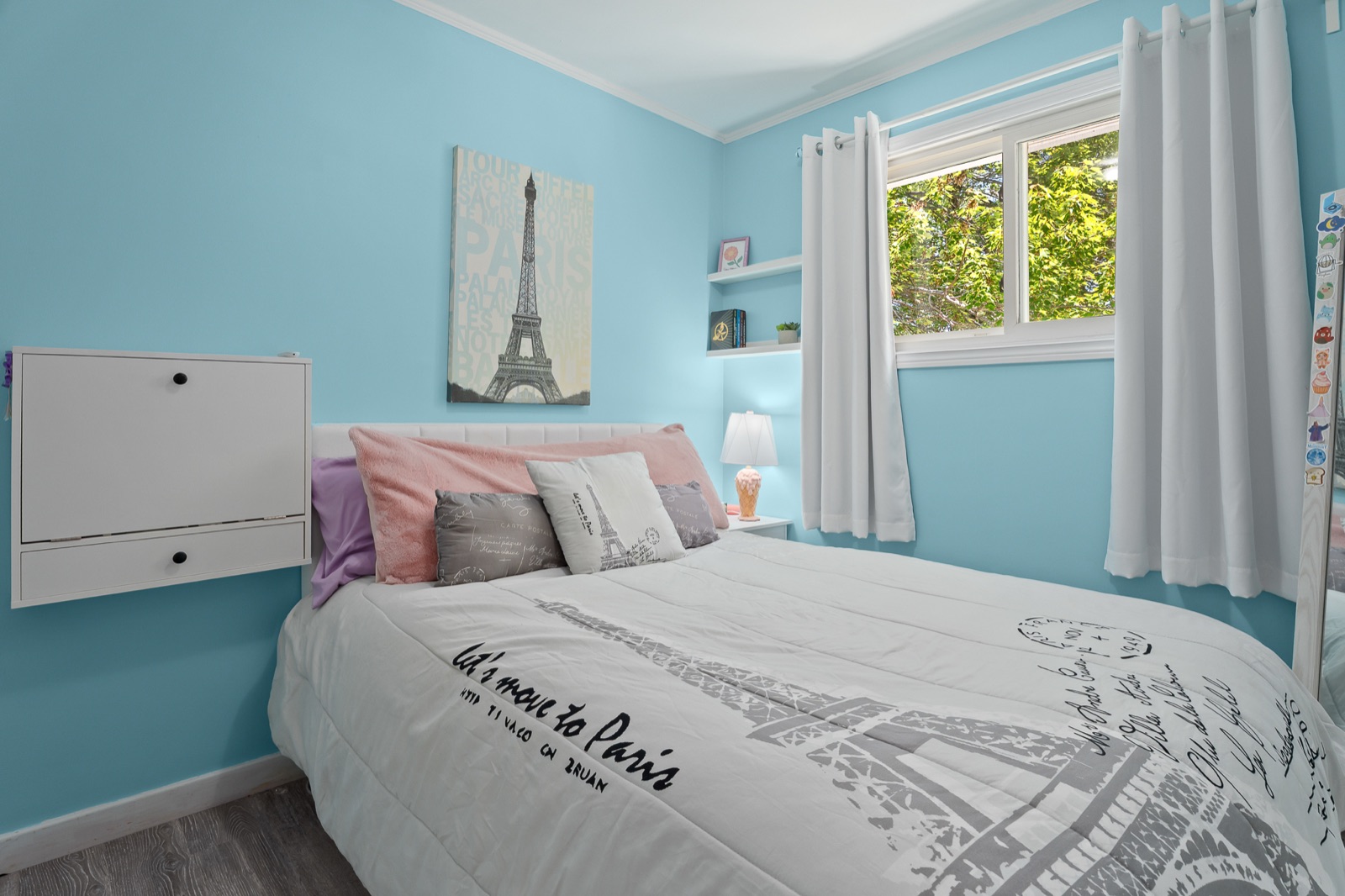 Blue bedroom with a Paris-themed duvet