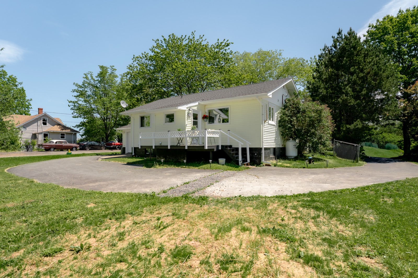 The home from the circular paved driveway