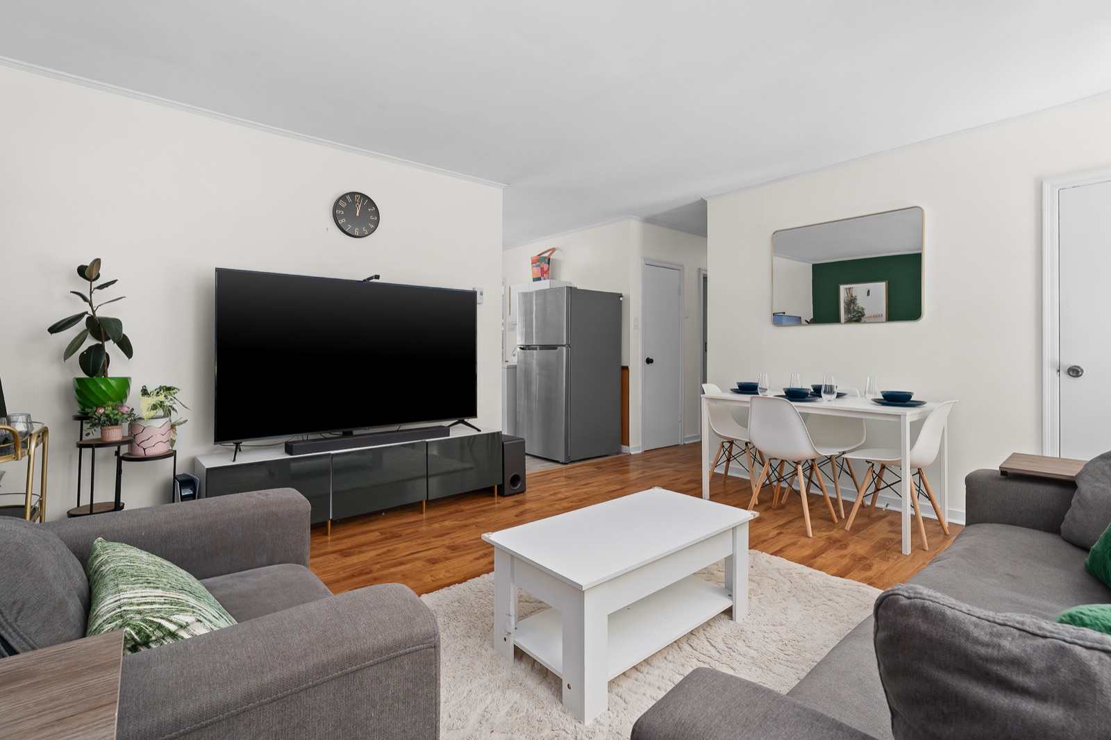 Living room with grey sofas and the deep green accent wall