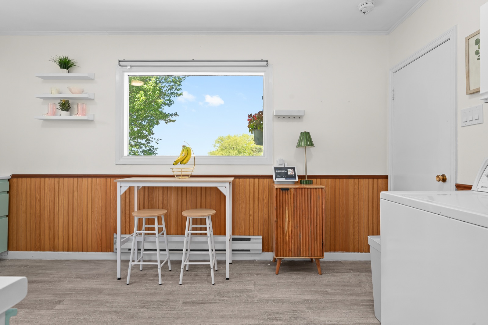 Breakfast bar nook with wood wainscoting and a sunny window